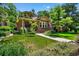 Charming brick home featuring a well-manicured lawn and professionally landscaped front yard at 836 Steele St, Denver, CO 80206