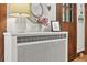 Radiator in hallway, featuring decorative cover and providing efficient heating in the home's interior at 836 Steele St, Denver, CO 80206