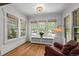 Bright sunroom with large windows offering natural light and hardwood flooring at 836 Steele St, Denver, CO 80206