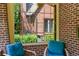 Porch view through window with brick exterior and blue cushioned seating at 836 Steele St, Denver, CO 80206