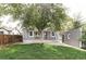 A charming home with a well-manicured lawn and a mature tree in the backyard at 2655 S Humboldt St, Denver, CO 80210