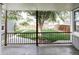 View of a well-maintained backyard with a large tree and wooden fence from a covered patio at 2655 S Humboldt St, Denver, CO 80210