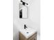 Modern bathroom vanity with a new sink, black hardware and a contemporary mirror at 2655 S Humboldt St, Denver, CO 80210