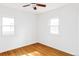 Bright empty bedroom featuring a ceiling fan, hardwood floors and white walls at 2655 S Humboldt St, Denver, CO 80210