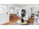 Elegant dining area with hardwood floors, a modern chandelier, and a glimpse into the kitchen at 2655 S Humboldt St, Denver, CO 80210