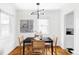 Bright dining area with a stylish chandelier, woven chairs, and a window view at 2655 S Humboldt St, Denver, CO 80210