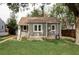 Charming gray home with a well-maintained lawn and a tire swing in the front yard at 2655 S Humboldt St, Denver, CO 80210