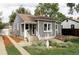 Inviting gray home featuring manicured landscaping and a quaint front entrance with steps at 2655 S Humboldt St, Denver, CO 80210