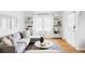 Bright living room featuring hardwood floors, a modern sofa, and built-in shelving at 2655 S Humboldt St, Denver, CO 80210