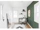 Bright office space with desk, shelving and large windows providing plenty of light at 2655 S Humboldt St, Denver, CO 80210