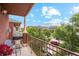 Balcony featuring gas grill, seating, and a view of trees, street and neighboring buildings at 2100 N Humboldt St # 302, Denver, CO 80205