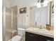 Bathroom featuring shower with glass door, single vanity with dark cabinetry, and decorative painting at 2100 N Humboldt St # 302, Denver, CO 80205