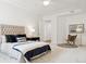 Inviting bedroom with tufted headboard, stylish accent chair, and ample natural light at 2100 N Humboldt St # 302, Denver, CO 80205