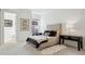 This bright bedroom showcases a tufted headboard and an ensuite bathroom entrance at 2100 N Humboldt St # 302, Denver, CO 80205