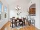 Charming dining room with a round table, chandelier, bar seating, and natural light at 2100 N Humboldt St # 302, Denver, CO 80205