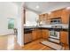 Stylish kitchen features stainless steel appliances and wood floors and cabinets at 2100 N Humboldt St # 302, Denver, CO 80205