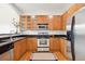 Kitchen with stainless steel appliances, granite countertops, and wooden cabinetry at 2100 N Humboldt St # 302, Denver, CO 80205