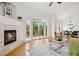 A living room with hardwood flooring, modern fireplace and balcony access is bright and airy at 2100 N Humboldt St # 302, Denver, CO 80205