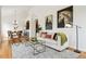 Living room with hardwood floors, sofa, and horse artwork at 2100 N Humboldt St # 302, Denver, CO 80205
