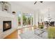 Bright living space with fireplace, hardwood floors, and sliding doors to balcony at 2100 N Humboldt St # 302, Denver, CO 80205