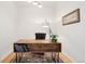 Minimalist office space with a modern wooden desk, soft lighting, and neutral decor at 2100 N Humboldt St # 302, Denver, CO 80205