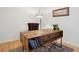 Office area with modern desk, stylish lamp, artwork, and wood floor, creating a work environment at 2100 N Humboldt St # 302, Denver, CO 80205