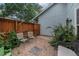 This brick back patio features outdoor seating and a wooden fence for privacy at 6937 S Knolls Way, Centennial, CO 80122