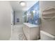 Modern bathroom featuring a blue tile wall, a tub with shower, and a granite vanity at 6937 S Knolls Way, Centennial, CO 80122