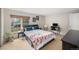 Bright bedroom featuring a window view, a comfortable bed, and a functional desk area at 6937 S Knolls Way, Centennial, CO 80122