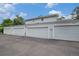 Attached gray garages provide parking and storage for this multi-unit building at 6937 S Knolls Way, Centennial, CO 80122