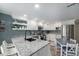 Open kitchen features white cabinets, granite countertops, and stainless steel appliances at 6937 S Knolls Way, Centennial, CO 80122