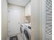 Convenient laundry room with washer, dryer, and overhead storage cabinets at 6937 S Knolls Way, Centennial, CO 80122