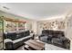 This living room has plush sofas, a center table, and a well-lit window at 6937 S Knolls Way, Centennial, CO 80122