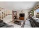 The living room has a brick fireplace, a large TV on stand, and a plush sofa at 6937 S Knolls Way, Centennial, CO 80122