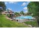 Community pool with lounge chairs surrounded by landscaped grounds at 6937 S Knolls Way, Centennial, CO 80122
