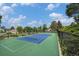 Outdoor community tennis court features green and blue surface, perfect for recreation at 6937 S Knolls Way, Centennial, CO 80122