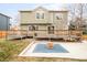 Spacious backyard featuring a deck, a concrete fire pit area, and a well-maintained lawn at 10063 Silver Maple Rd, Highlands Ranch, CO 80129