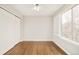 Empty bedroom with hardwood floors, ceiling fan, closet and shuttered windows at 10063 Silver Maple Rd, Highlands Ranch, CO 80129