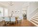 Elegant dining room with hardwood floors, modern chandelier and stairway at 10063 Silver Maple Rd, Highlands Ranch, CO 80129