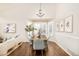 Dining room with wood floors, stylish chandelier, and large bay window with shutters at 10063 Silver Maple Rd, Highlands Ranch, CO 80129