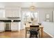 Bright kitchen with stainless steel appliances, and a wooden table with black chairs at 10063 Silver Maple Rd, Highlands Ranch, CO 80129