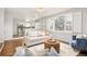 Open living room with hardwood floors seamlessly flows into the modern kitchen at 10063 Silver Maple Rd, Highlands Ranch, CO 80129