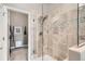 Bathroom with glass enclosed shower featuring decorative tile and neutral paint at 12715 Madison St, Thornton, CO 80241