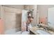 Bathroom featuring granite countertops, a shower with tile surround, and decorative shelving at 12715 Madison St, Thornton, CO 80241