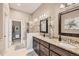 Bathroom with double sink vanity, granite countertops, decorative tile, and glass enclosed shower at 12715 Madison St, Thornton, CO 80241