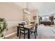 Inviting dining area featuring a stylish chandelier and a seamless transition to the kitchen at 12715 Madison St, Thornton, CO 80241