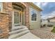 Charming entrance with stone accents, leading to a cozy home with inviting curb appeal at 12715 Madison St, Thornton, CO 80241