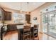 Kitchen featuring dark wood cabinets, stainless steel appliances, and island with barstool seating at 12715 Madison St, Thornton, CO 80241