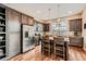 Well-lit kitchen featuring stainless steel appliances, a center island, and dark wood cabinets at 12715 Madison St, Thornton, CO 80241