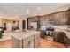 Kitchen featuring stainless steel appliances, a center island, and dark wood cabinets at 12715 Madison St, Thornton, CO 80241